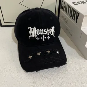 Distressed black baseball cap with Gothic embroidery and metal studs in streetwear style