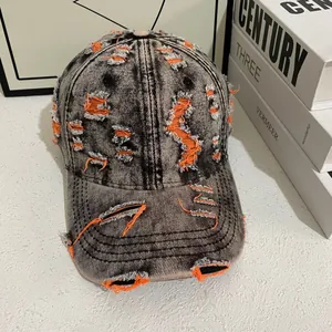 Close-up of vintage distressed denim baseball cap with orange inner lining detail