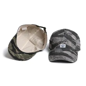 Detail view of cotton camo camper cap showing interior lining and material label