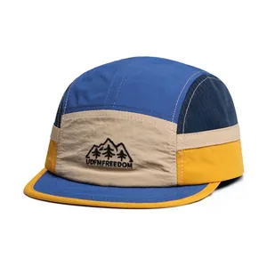 Close-up of embroidered mountain patch and UDFMFREEDOM text on five-panel nylon camping hat