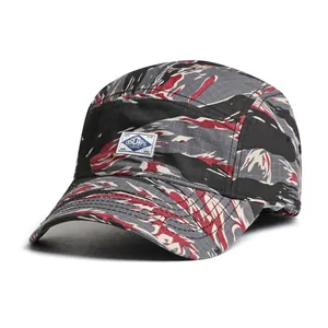 Detail of tiger camo ripstop fabric and woven logo on this five-panel camping cap