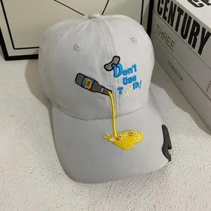 Detail of baseball cap with creative embroidery and metal bottle opener on the brim