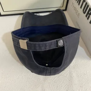 Detailed back view of vintage washed cotton baseball cap with silver metal buckle
