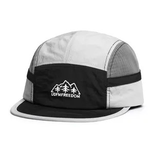 Detailed close-up of quick-dry five-panel camper hat with mesh vents and mountain embroidery
