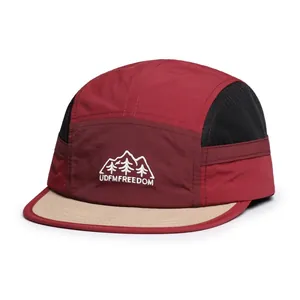 Detail of 5-panel outdoor camper hat with breathable black mesh and mountain embroidery