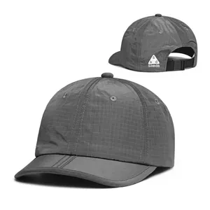 Detail of dark grey ripstop nylon baseball cap with adjustable buckle and back logo