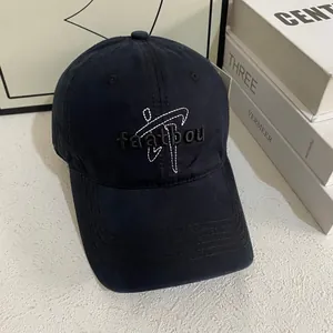 Close-up of black cotton baseball cap featuring 3D embroidered lettering and curved brim