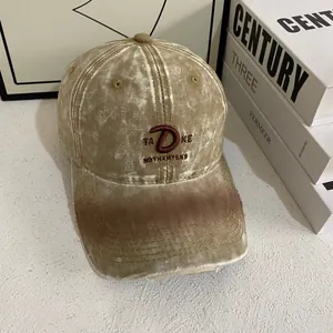 Detail of khaki washed canvas baseball cap with vintage embroidery and distressed brim