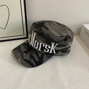 Close-up of MORSK embroidery and red star detail on camouflage military cadet cap