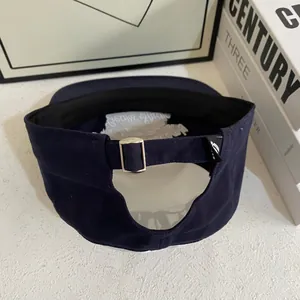 Navy blue baseball cap with embroidery, rear view showing adjustable metal buckle strap