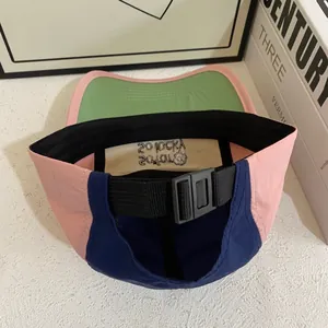 Close-up of adjustable buckle and inner sweatband on a tricolor patchwork baseball cap