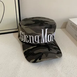Macro shot of 3D white embroidered logo on a jungle camouflage military cadet cap