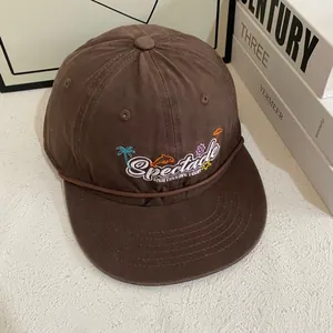 Detail of coffee brown cotton baseball cap featuring colorful summer theme embroidery