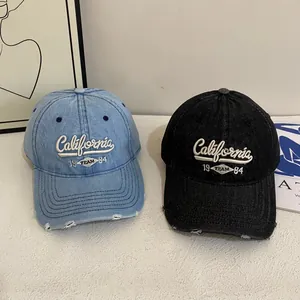 Vintage distressed denim baseball cap with California embroidery and ripped brim detail
