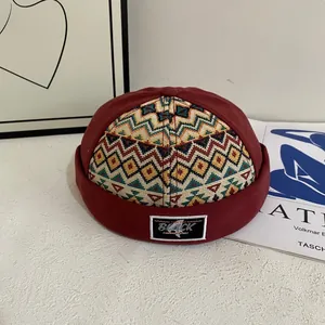 Vintage burgundy docker hat with ethnic woven pattern and black label for street style