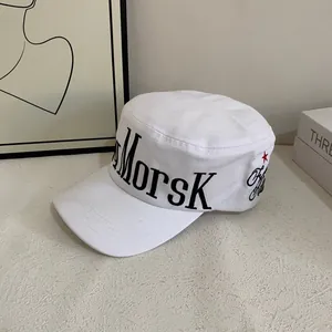 Detail of white cotton flat top military cap with MORSK embroidery and red star