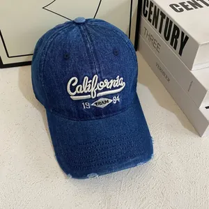 Vintage distressed blue denim baseball cap with California 1984 embroidery and wide brim