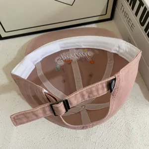 Detail showing the internal construction of the pink cotton baseball cap with embroidery