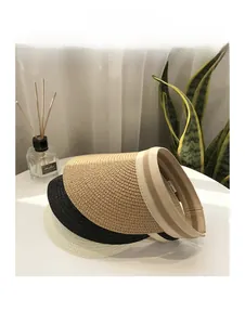 Detailed macro view of woven straw sun visors in khaki, black, and beige colors