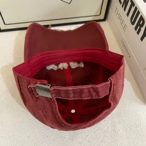 Detail view of burgundy baseball cap with vintage washed cotton and metal buckle