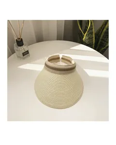 Detail of wide straw sun visor brim with striped elastic band in home setting