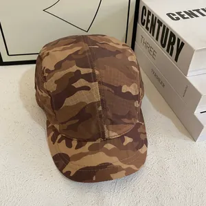 Detail of five-panel camo cap in brown earth tones with durable ripstop texture