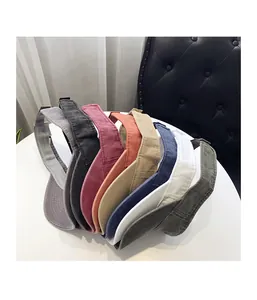Detailed top view of various colored cotton sun visors arranged on a table