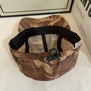 Detail of camouflage camping cap showing drawstring adjustment and internal sweatband