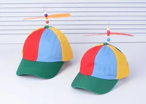 Detail of color-block propeller hats in adult and child sizes for parent-child matching