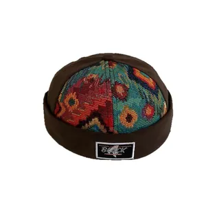 Retro brimless docker hat with dark brown canvas and colorful ethnic jacquard details