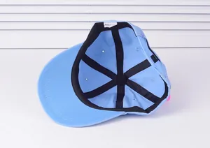 Detailed view of the blue baseball cap interior with wash label and reinforced strap