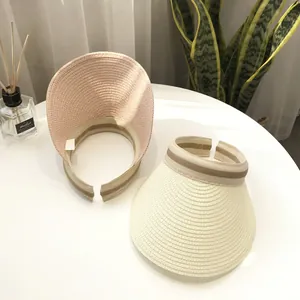 Women's woven straw sun visor hat with wide brim in pink and beige colors