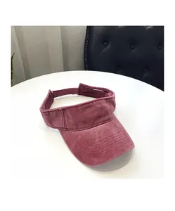 Detail of rose red sun visor with washed cotton texture and reinforced brim stitching