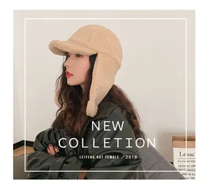 Detail of cream plush earflap trapper hat featuring textured faux sheepskin wool