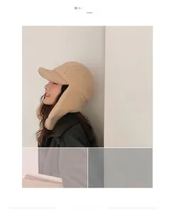 Detail view of the soft beige plush texture and earflaps on the warm winter trapper hat