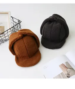 Close-up of thick sherpa fleece trapper hats in caramel and dark brown textures
