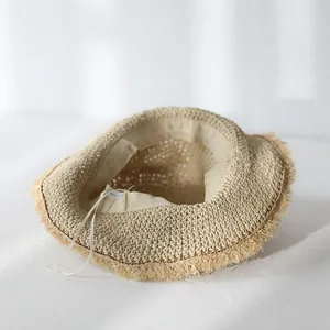 Handmade crochet straw sun hat for women with wide brim tassel edges for beach vacations