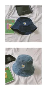 Close-up of daisy embroidery on blue denim bucket hats with high-quality texture