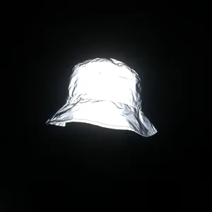 Detailed view of high-reflectivity silver fabric texture on a bucket hat with dark background