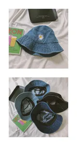 Detailed close-up of embroidered daisy patterns on various denim bucket hats