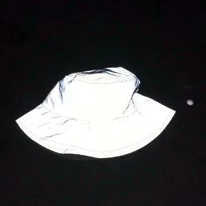 Macro shot of reflective silver-gray bucket hat showing high-visibility fabric detail