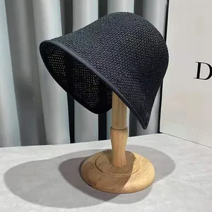Chic black woven straw bucket hat with fine crochet design for summer sun protection
