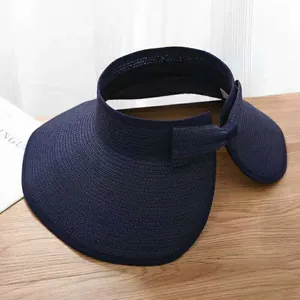 Detail of navy blue straw sun hat with elegant bow and fine woven texture design