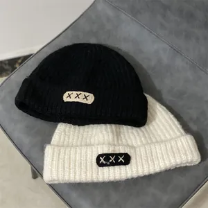 Winter chunky knit beanie hats in black and white with stylish embroidered patch