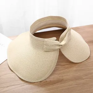 Detail of the woven straw texture and open top design on this wide brim sun hat