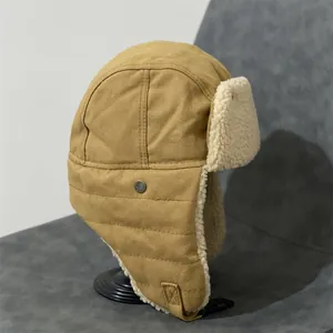Detail of khaki aviator hat showing thick white faux shearling lining and buckle strap