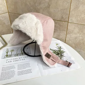 Dettaglio del cappello aviatore rosa in finta pelle con pelliccia bianca e fibbia