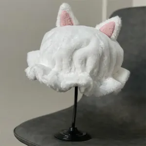 Cute white plush cat ear beanie hat with pink inner lining on a display stand