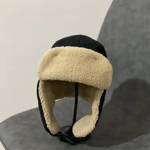 Detailed close-up of thickened thermal lining and windproof buckle on black aviator hat