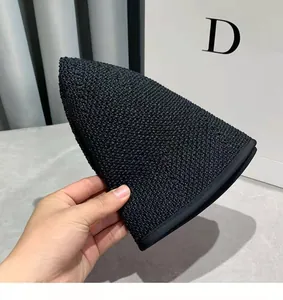 Close-up of the black finely woven breathable material and soft texture of the sun hat